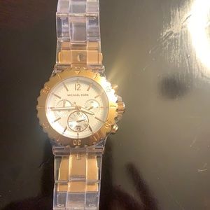 Michael Kors watch. Gold  stainless steel. Clear lucite band. Needs battery.